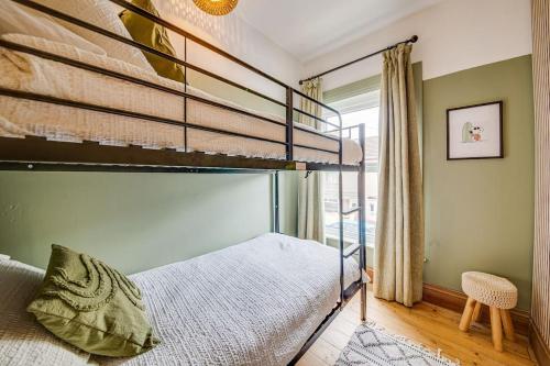 a bedroom with two bunk beds and a window at Boho Beach House: Hot Tub in Cleethorpes