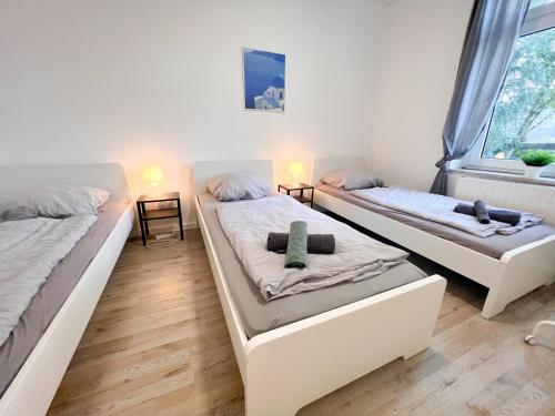 two beds in a room with two windows at 3 Zimmer mit 6 Betten, große Küche, neues Bad, 7min zur A1 in Hagen