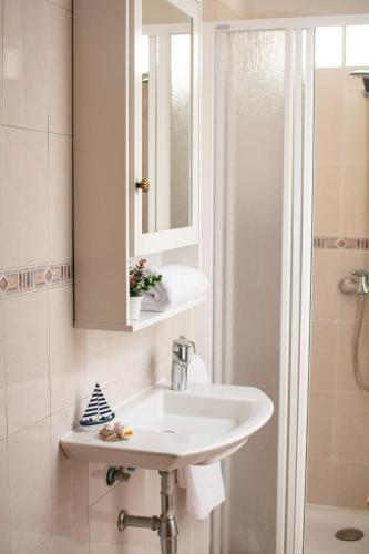 a bathroom with a sink and a mirror and a shower at Casa Siroco Sol in Playa Honda