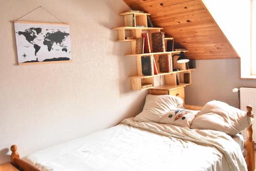 a person laying on a bed in a bedroom at Chambres chez l'habitant - Chez Nico & Belen 