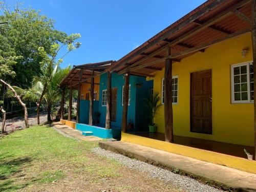 a house with a yellow and blue at Hostal Aguas Verdes in Santa Catalina