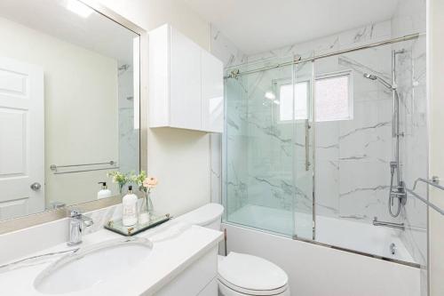 a bathroom with a shower and a toilet and a sink at Home near Downtown Vancouver East@ Joyce Skytrain in Vancouver