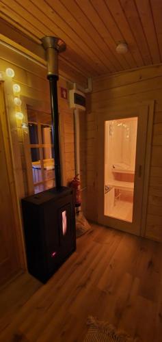 a woodburning stove in a room in a cabin at Hiska Na Samem v Slovenj Gradcu in Slovenj Gradec