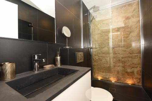 a bathroom with a sink and a shower at Cosy flat - Saint germain in Paris