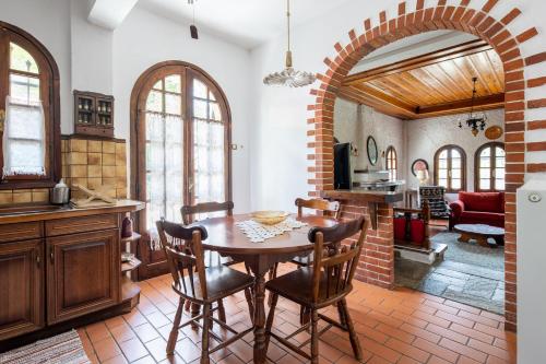 a kitchen and dining room with a table and chairs at Zenios Dionysos - Traditional villa in Grevena