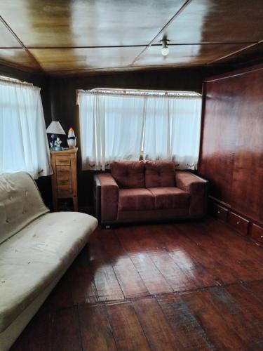 a living room with a couch and a window at Casa Lila in Mineral del Monte