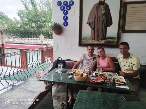 a group of three people sitting at a table with food at Solomon's Mansion Hotel Istanbul in Istanbul