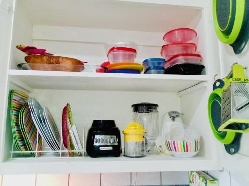 a kitchen pantry with dishes and other kitchen utensils at Idyllic Beachfront Condo in Ocho Rios