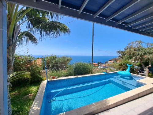a swimming pool with a view of the ocean at Canto da Manu Panoramic in Calheta
