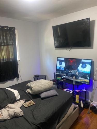 a bedroom with a bed and a flat screen tv at Nice stay in Calumet City. in Calumet City