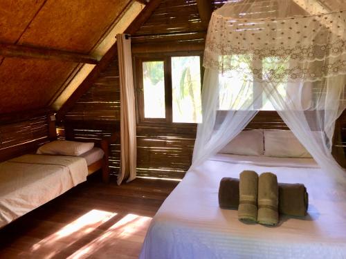 a bedroom with two beds and a window at Sitio Simple Life in Ubatuba