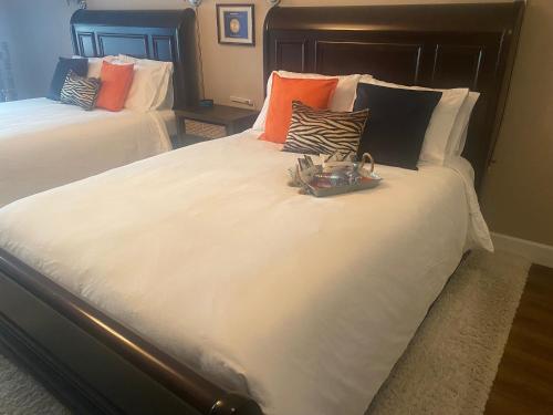 a large white bed with pillows and a tray on it at Rockwood House in Nanaimo