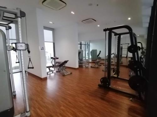 a gym with treadmills and exercise equipment in a room at City View Studio in Phnom Penh
