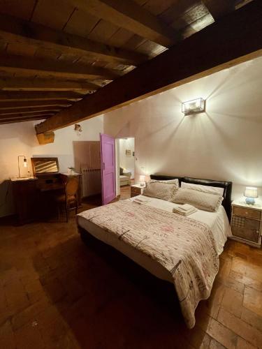 a bedroom with a large bed and a desk at Modì Loft in Livorno