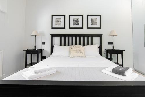 a bedroom with a large white bed with two tables at Villa Mare in Mákri