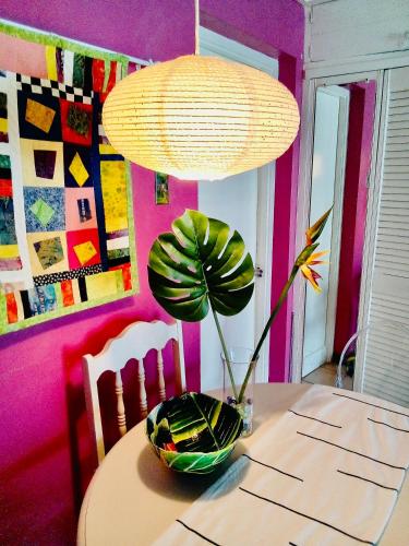 a dining room table with a lamp and a plant on it at Idyllic Beachfront Condo in Ocho Rios