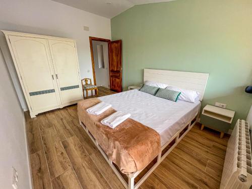 a bedroom with a bed with two towels on it at Casa Yama - Renovated House in the Center of Berga in Berga