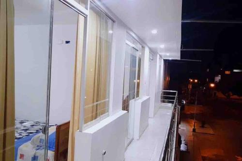 a room with a balcony with a glass window at Moderno y nuevo departamento “Casa Blanca” in Trujillo