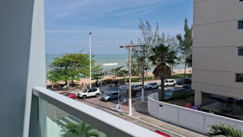a balcony with a view of a parking lot at Studio pé na areia, vista, internet e ar in Macaé