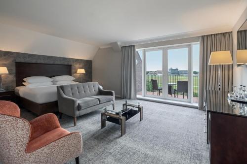 a hotel room with a bed and a balcony at Delta Hotels by Marriott York in York