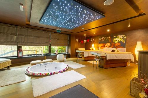 een slaapkamer met een bad in het midden van een kamer bij Poiana Brasov Alpin Resort Hotel Aparthotel 2204, private property in Poiana Brasov