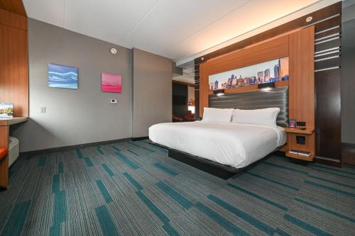 a hotel room with a large bed in a room at Aloft Charlotte City Center in Charlotte