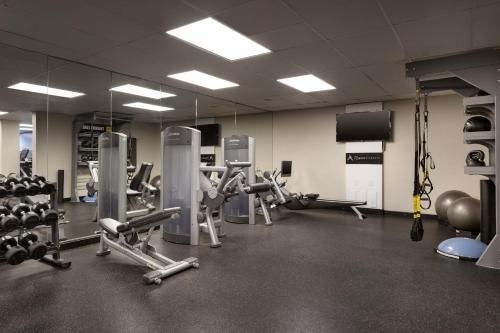 a gym with lots of machines and a large mirror at Torrance Marriott Redondo Beach in Torrance