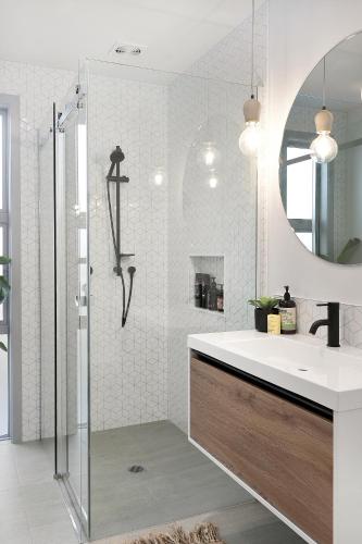 a bathroom with a sink and a shower at Hillside Haven, House and Unit, Spa Pool in Raglan