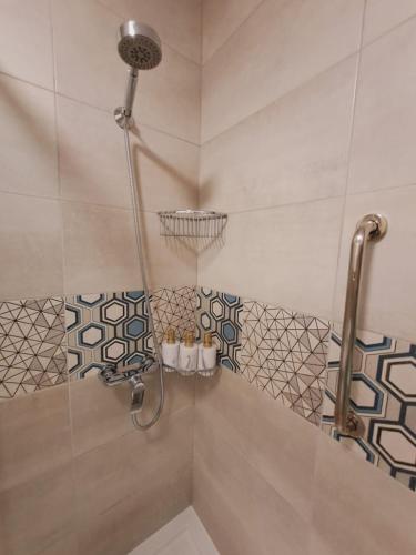 a bathroom with a shower with a shower head at Limanowa Sunriser Apartment in Limanowa