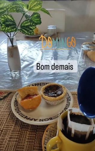 a table with two pies and a cup of coffee at Pousada Flor de Lótus Suites Carneiros in Tamandaré