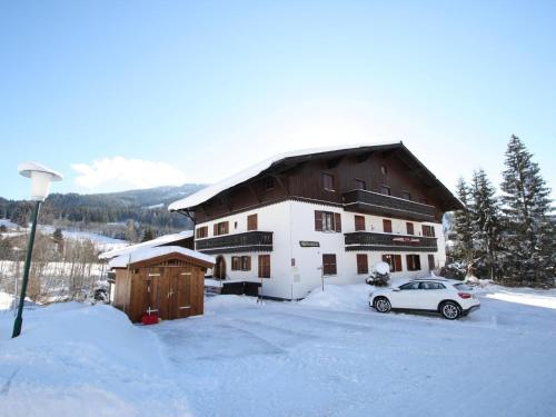 a house with a car parked in the snow at Sonnleiten 15 in Maria Alm am Steinernen Meer