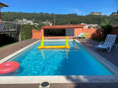 a pool with a slide at Casa Azevedo in Vila Nova de Famalicão