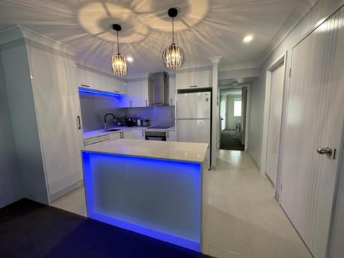 a kitchen with a blue lighted island in a kitchen at Bayview Bay Apartments and Marina in Gold Coast