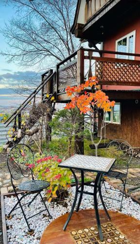 a table and two chairs and a table with a plant at Sapporo Luxury Log House 5Brm max 18ppl 4 free parking in Sapporo