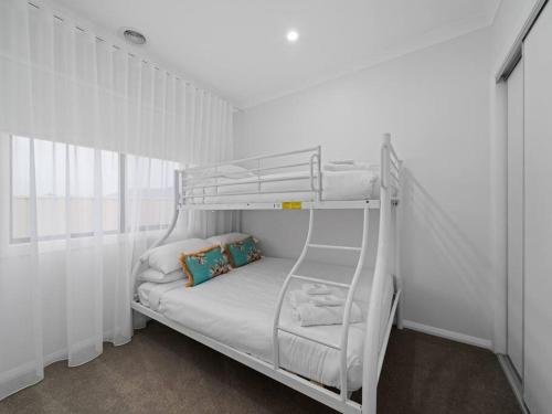 a white bunk bed in a white room at Clio on the corner in Shepparton