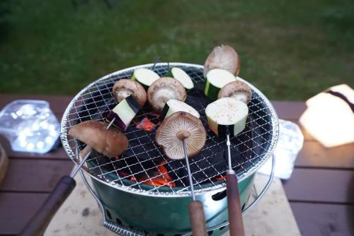 a grill with mushrooms and other foods on it at Sapporo Luxury Log House 5Brm max 18ppl 4 free parking in Sapporo