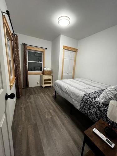 a bedroom with a bed and a television in it at Bethel Woods Cabin in Mongaup Valley