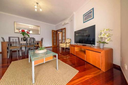 a living room with a television and a dining room at Alex Apartment by Mth in Funchal