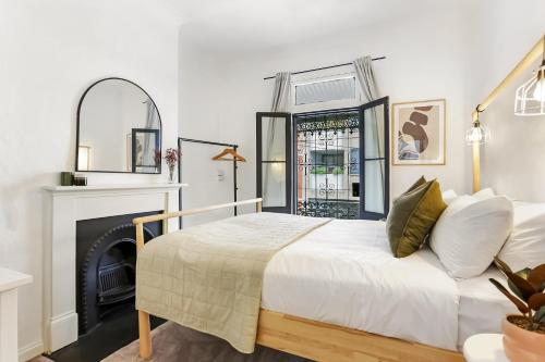 a bedroom with a bed and a fireplace at Surry Hills l 2 Bedroom Terrace Home in Sydney