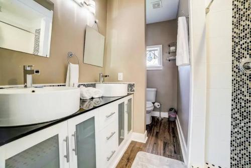 a bathroom with two sinks and a shower at Southtown Downtown Home Walk to Riverwalk in San Antonio