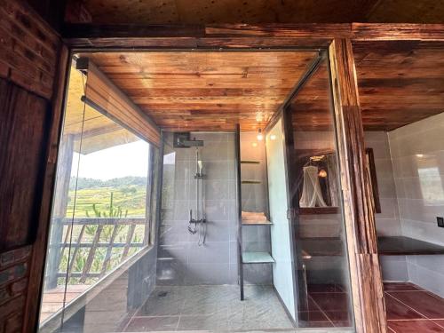 a bathroom with a shower and a large window at Mu Cang Chai Eco Lodge in Nam San