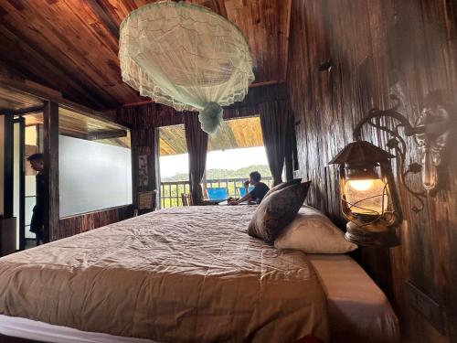 a bedroom with a bed with a chandelier at Mu Cang Chai Eco Lodge in Nam San