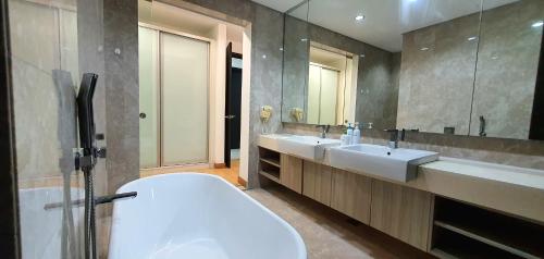 a bathroom with two sinks and a large mirror at The Elements Ampang Infinity Pool in Kuala Lumpur