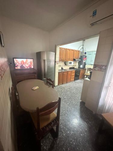 a kitchen with a table and a refrigerator at Casa Lola in Mendoza