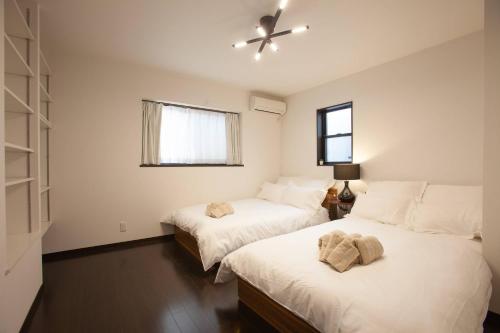 a bedroom with two beds and a window at KS west Waseda 2F in Tokyo