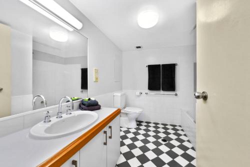 a white bathroom with a sink and a toilet at Gena Apartments Unit 13 Kings Beach QLD in Caloundra