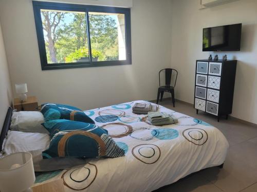 a large bed in a room with a window at Gîte tout confort avec spa, PMR, clim' réversible, randonnées, activités et spécialités locales - FR-1-489-476 in Couzon