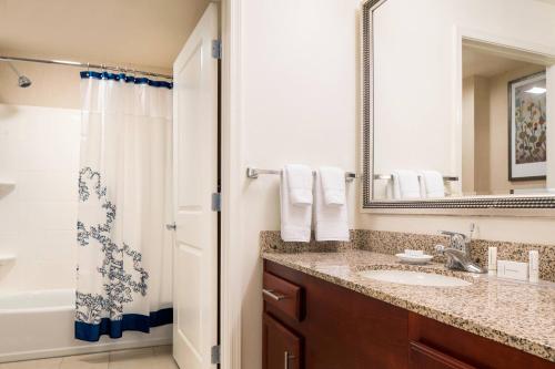 a bathroom with a sink and a tub and a mirror at Residence Inn Phoenix Desert View at Mayo Clinic in Phoenix
