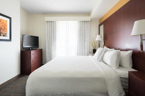 a hotel room with a bed and a flat screen tv at Residence Inn Phoenix Desert View at Mayo Clinic in Phoenix