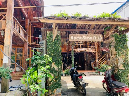 a couple of motorcycles parked in front of a building at A Lử Homestay in Mù Cang Chải